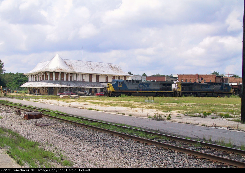 CSX 235 leads a coal train past the unrestored station